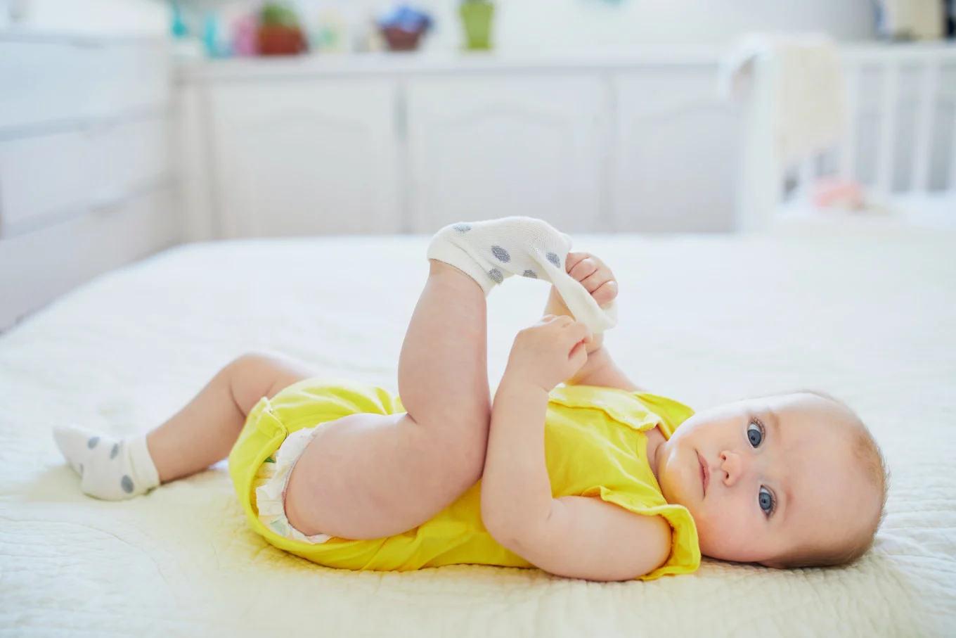 baby girl playing with socks