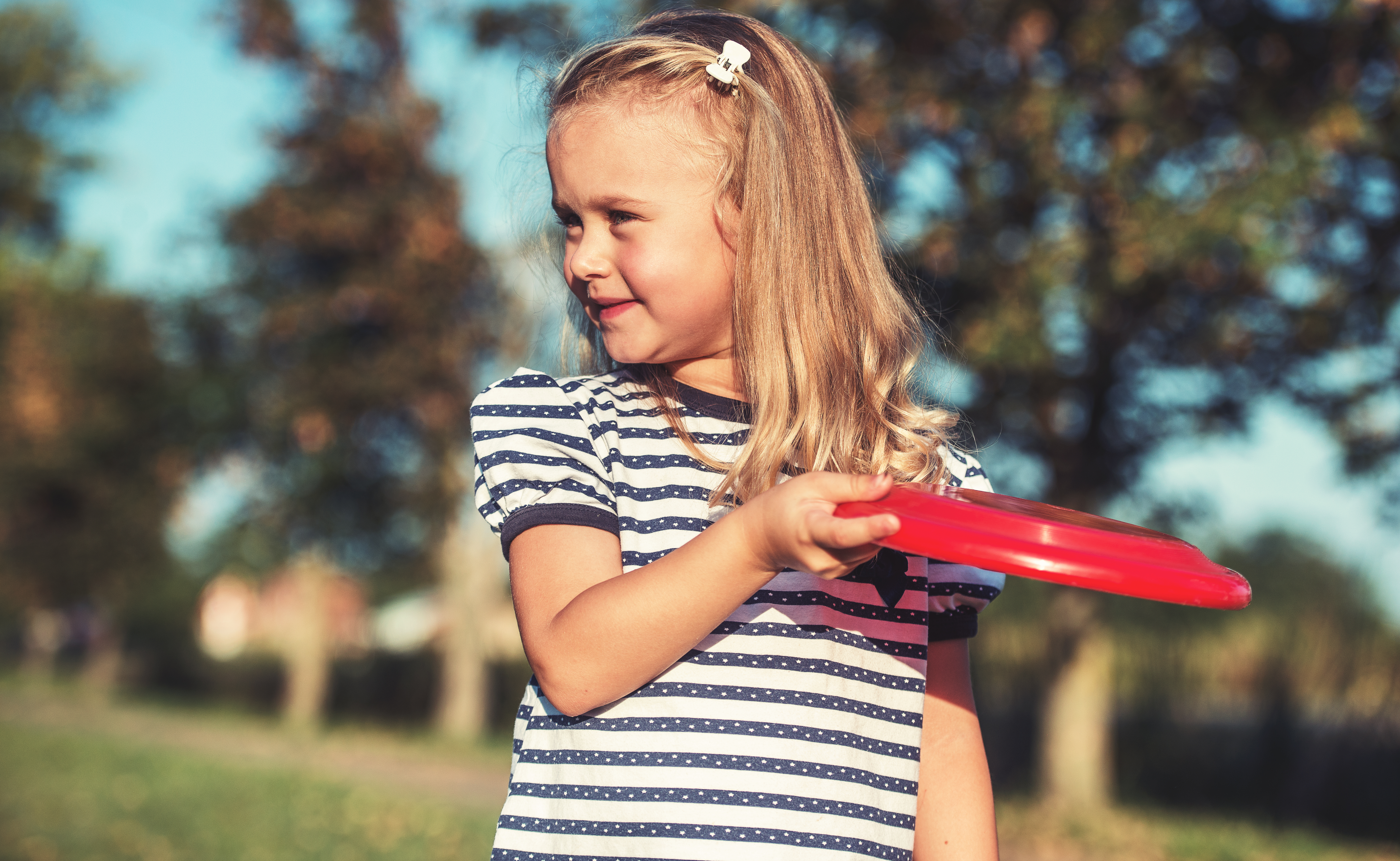 little girl throwing a frisbee-placeholder