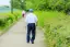 an old man walking away viewed from the back-placeholder