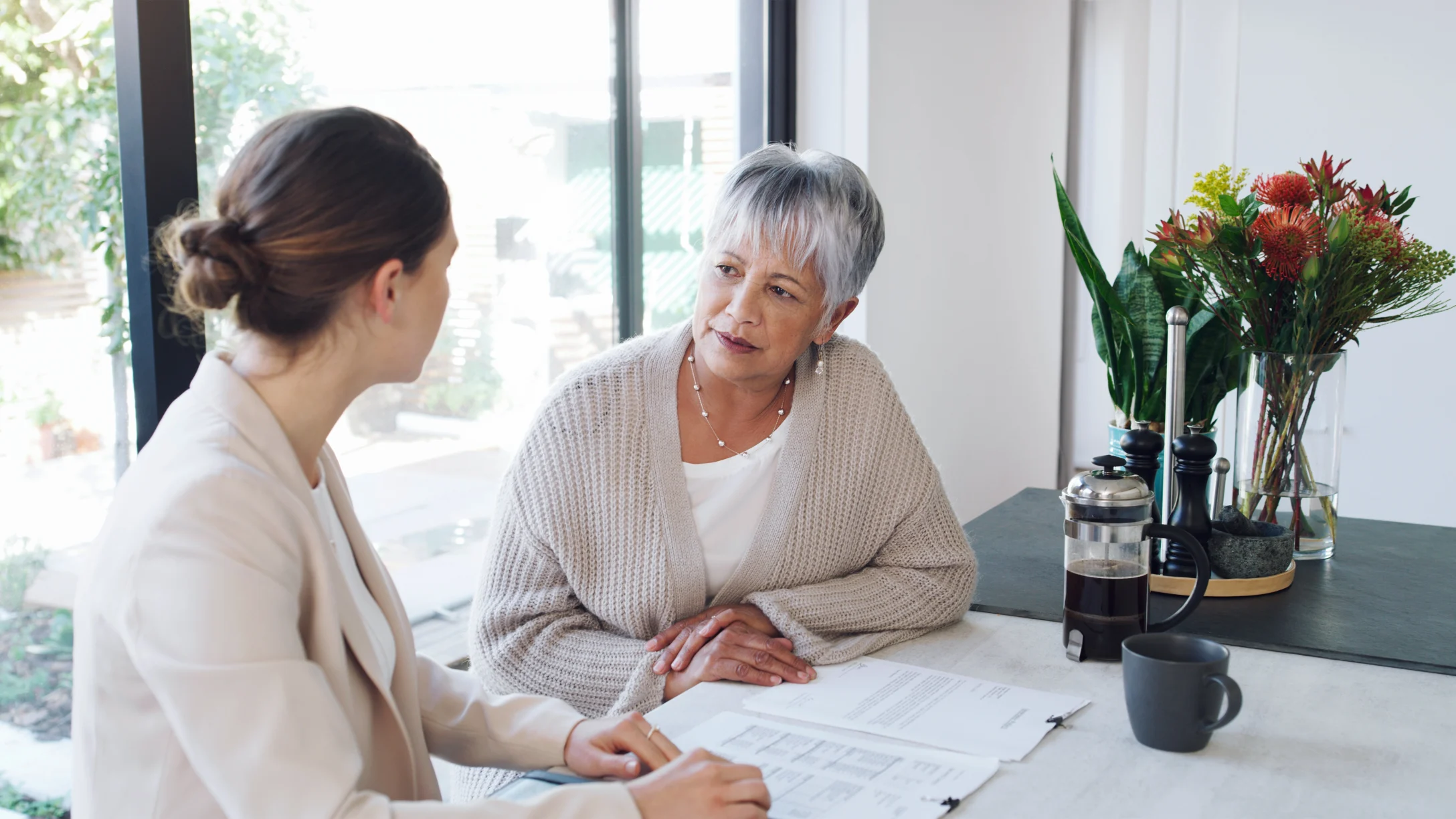 two women talking about paperwork