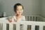 baby girl standing in crib-placeholder