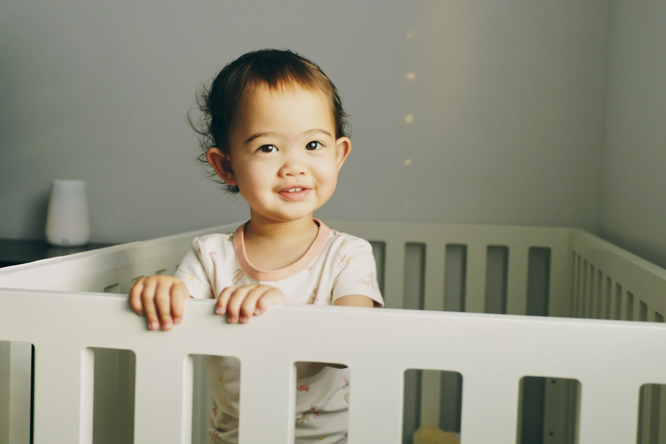 baby girl standing in crib