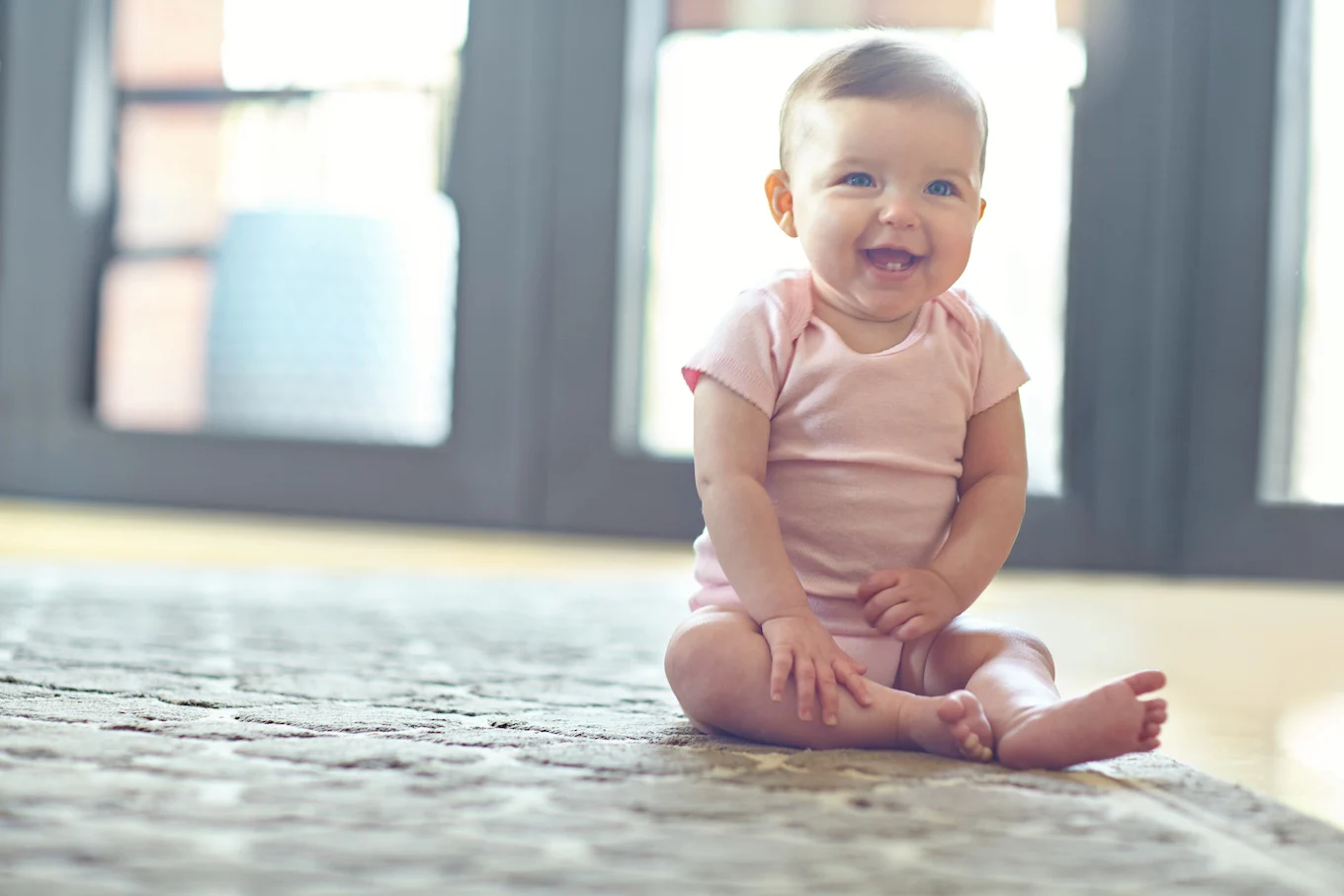 baby girl in pink onesie