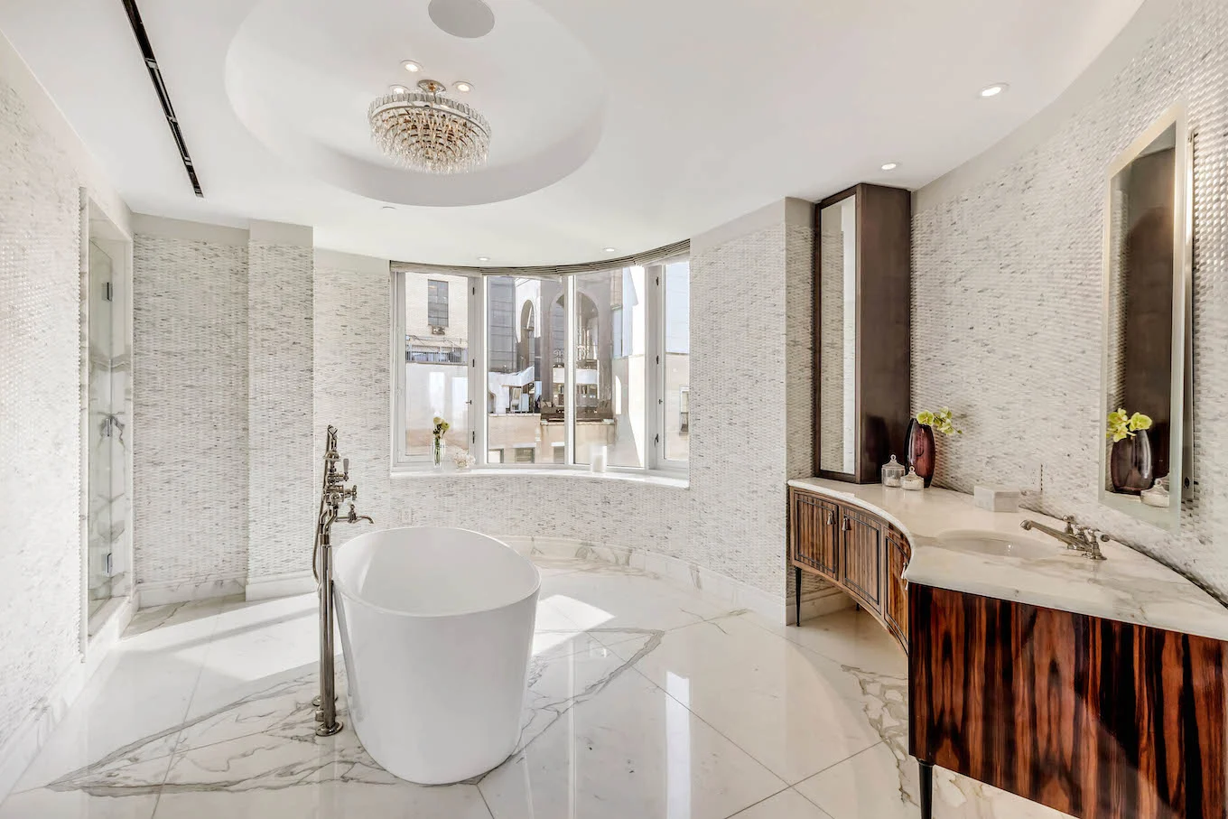 Penthouse marble bathroom with tub